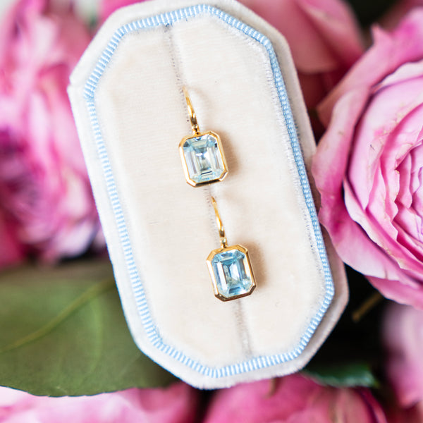 Bezel Set Emerald Cut Blue Topaz Earrings in 14k Yellow Gold