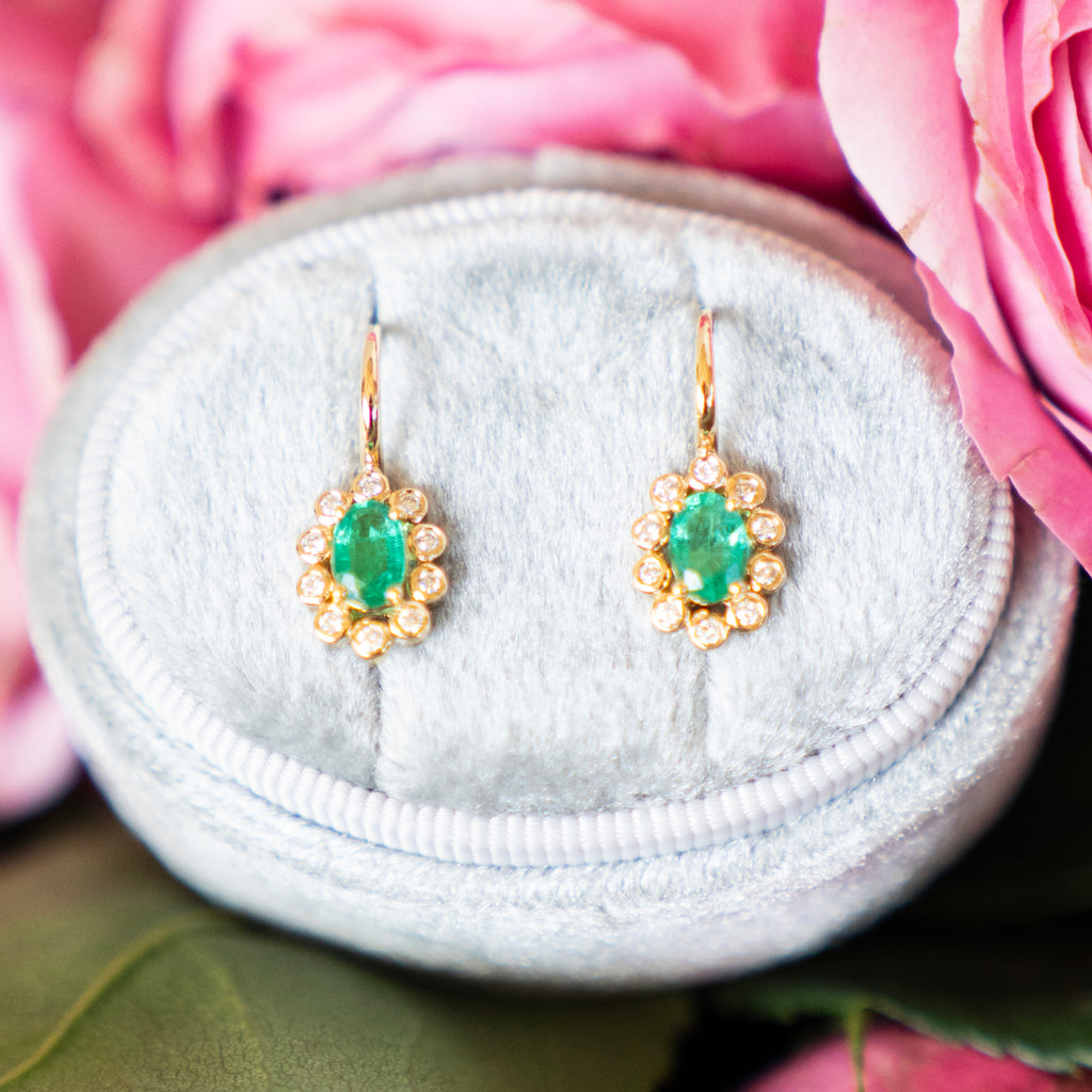 Oval Cut Emerald and Bezel Set Diamond Halo Earrings